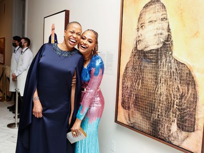 Rhea L. Combs (left) and Ava DuVernay (right) share a laugh in front of DuVernay&rsquo;s portrait during the National Portrait Gallery&#39;s 2022 Portrait of a Nation Gala on Saturday, November 12, 2022.