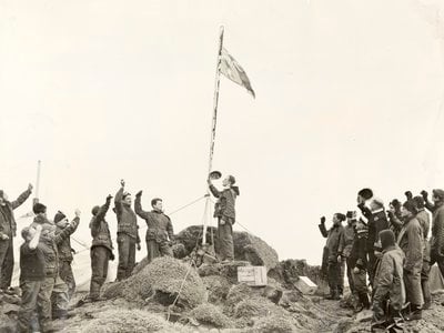Members of the Australian National Antarctic Research Expedition raise the Australian flag over Heard Island on December 26, 1947.