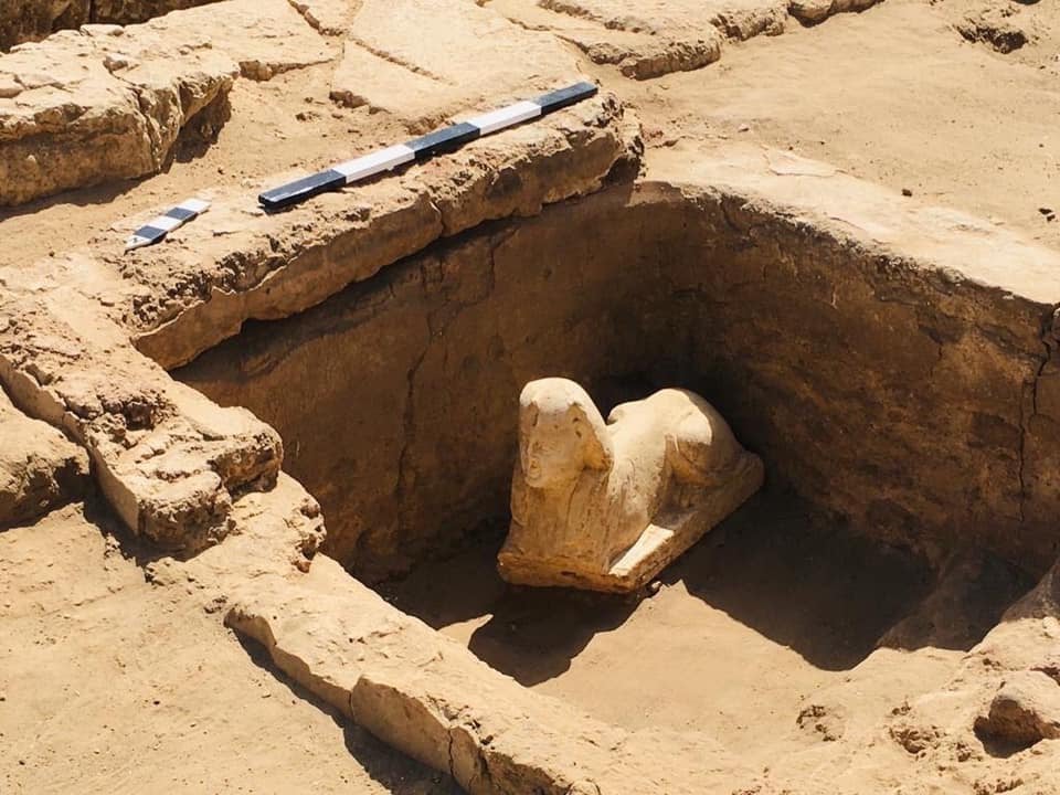 Statue of sphinx inside a rectangular hole dug out of the ground