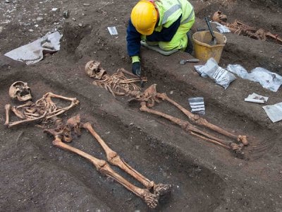 Archaeologists excavate the remains of friars buried at the former Augustinian friary in central Cambridge.