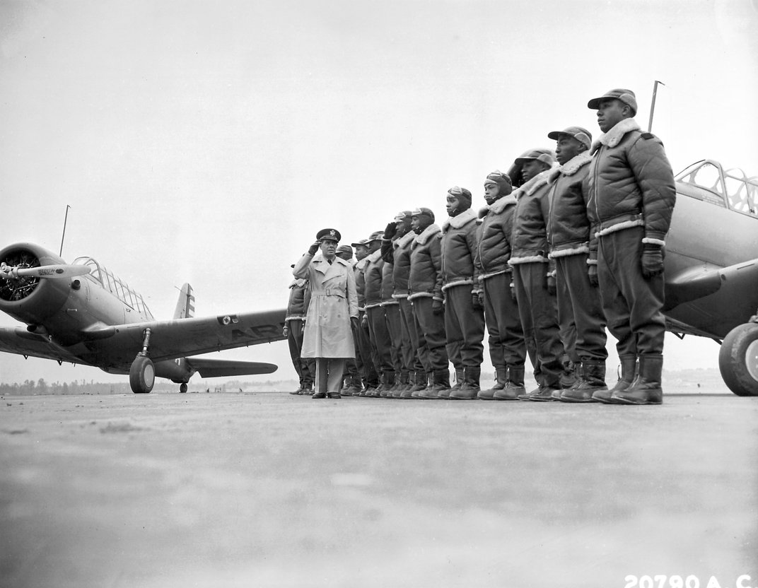 Major James A. Ellison returns the salute of Mac Ross as he reviews the first class of Tuskegee Airmen cadets in 1941