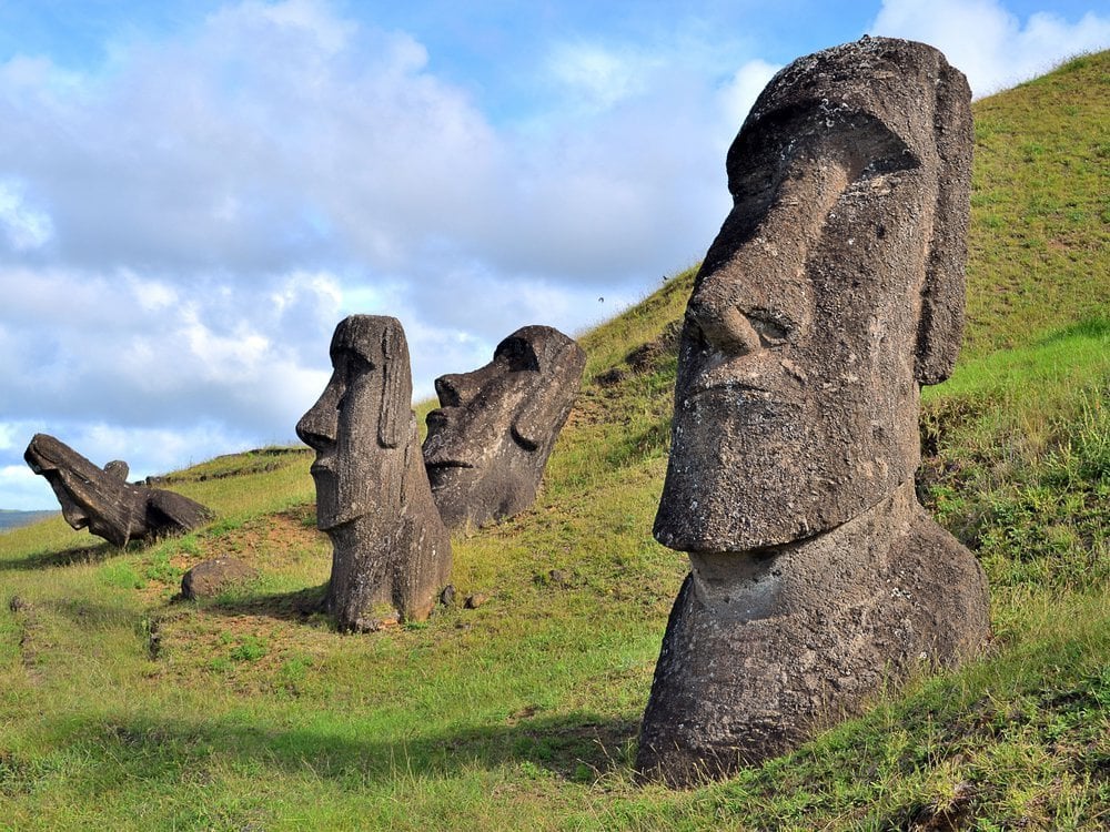 Large head-shaped statues on green island