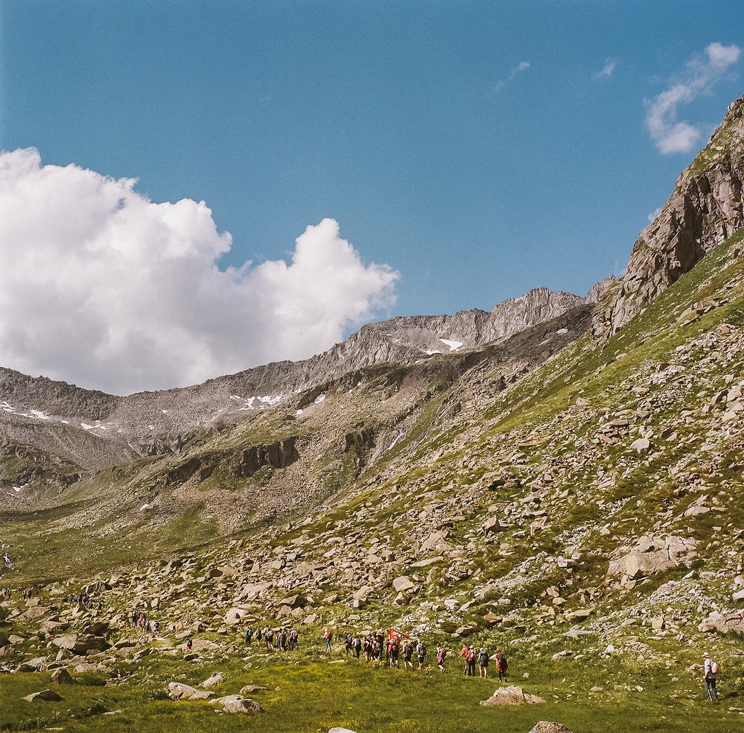Hikers continue the ascent during the Alpine Peace Crossing.