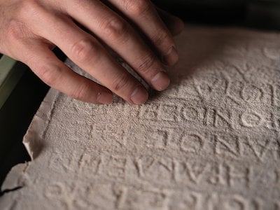 A copy of a Greek inscription, made by laying wet paper or plaster over carved stone to create a mirror-image impression.