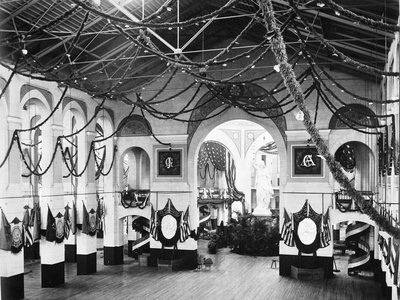 Smithsonian’s Arts and Industries building decorated for James Garfield’s inaugural ball, complete with string light garlands and patriotic buntings.