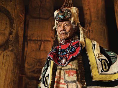At the Totem Heritage Center in Ketchikan, Alaska, Nathan Jackson wears ceremonial blankets and a headdress made from ermine pelts, cedar, abalone shell, copper and flicker feathers.
