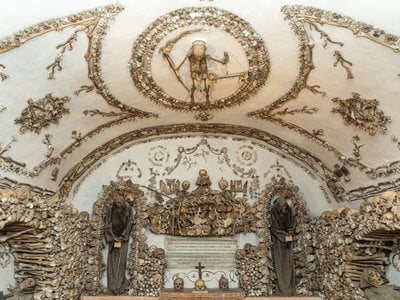 Skeletons adorn the walls and ceilings of the crypt, like 3D paintings.